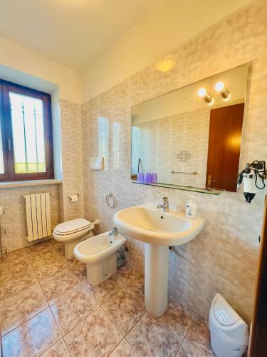a bathroom with a sink and a toilet at Residence Corte del Bosco in Garda