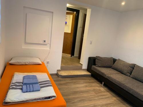 a living room with a couch and a chalkboard at Seven’S Apartments in Löhnberg