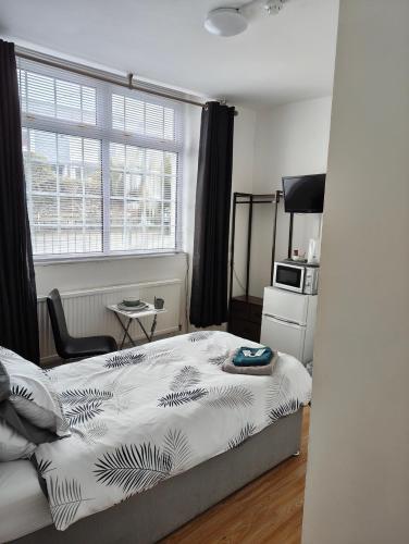 a bedroom with a bed in front of a window at Tredegar Arms Budget Guesthouse For Walkers/Cyclists/Contractors/Traveler in Merthyr Tydfil