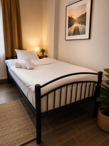 a bedroom with a large bed with white sheets at Mini hotel in centre in Yerevan