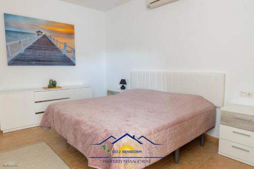 a bedroom with a bed and a painting on the wall at Altea Hillside Harmony in Altea