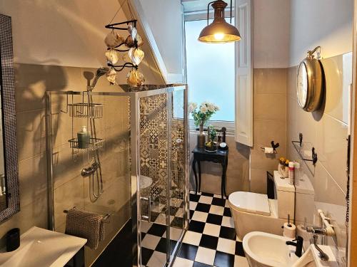 a bathroom with a shower and a toilet and a sink at alojamento maritimo II in Espinho