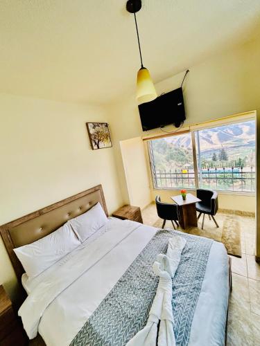 a bedroom with a large bed and a television at Jadara view in Irbid