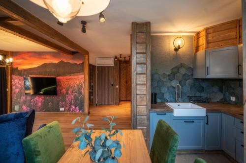 a kitchen and dining room with a wooden table at Mountain Shelter Apartments in Zakopane