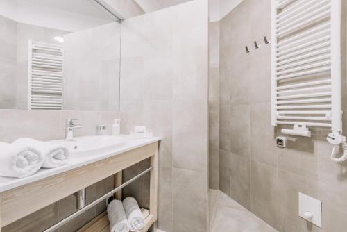 a bathroom with a sink and a shower at Green Loft Gdynia in Gdynia