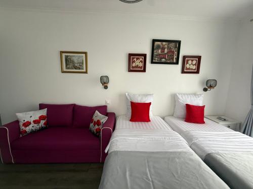 a living room with two beds and a purple couch at Paris Dream Villa in Villejuif
