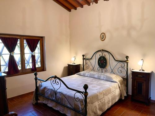 a bedroom with a bed and two lamps on tables at Agriturismo IL VIAIO in Fiesole