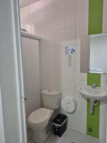 a small bathroom with a toilet and a sink at caribepremiumvalledupar in Valledupar