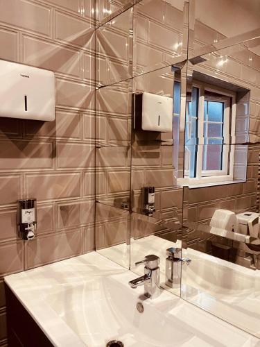 a bathroom with a sink and a mirror at Motel M69 in Leicester