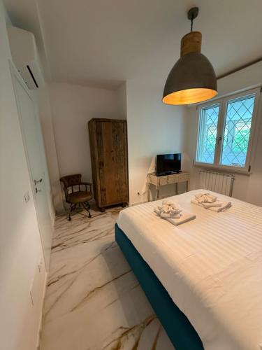 a bedroom with a large white bed in a room at Effealatapartments - L'Oasi del Forte in Forte dei Marmi