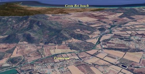 an aerial view of a city with a mountain at Casa Francesca in Costa Rei