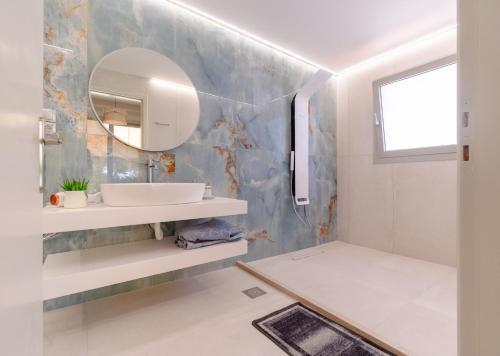 a bathroom with a sink and a mirror at Pension Alexandros in Preveza