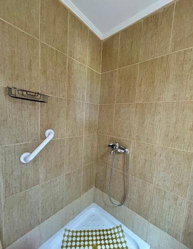a bathroom with a shower with a bath tub at Asprovalta Rooms in Asprovalta