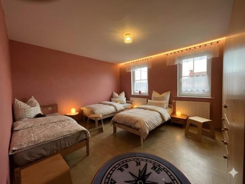 a room with two beds and two windows at Herrenhaus Gut Buchenhof in Römhild