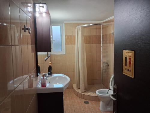 a bathroom with a sink and a shower and a toilet at TAKIS HOUSE in Káto Panayía
