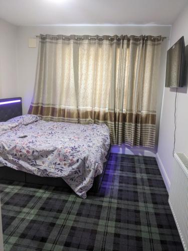 a bedroom with a bed and a window with curtains at Hotel vibe at home in Edenderry