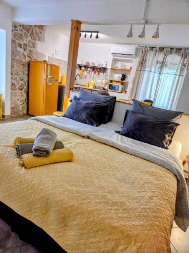 a large bed with two towels on top of it at Studio apartmani Šverko in Punat