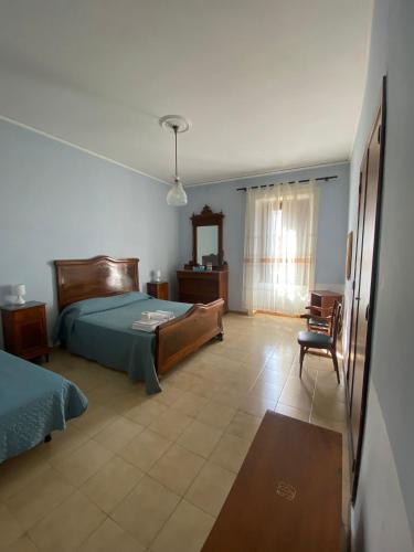 a bedroom with a bed and a chair at Antica Residenza in Perdifumo
