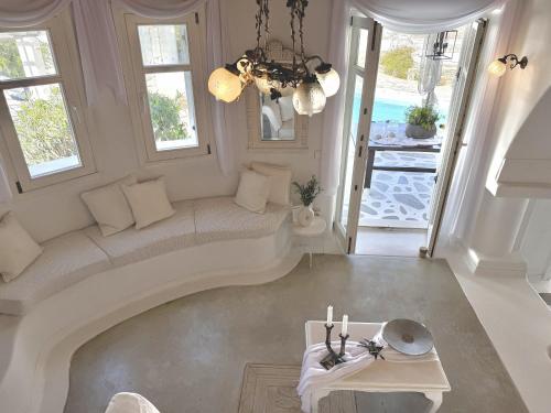a living room with a couch and a table at Villa ELAYA in Mikonos