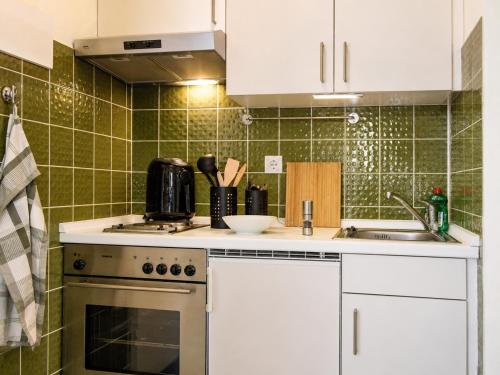 a kitchen with a stove and a sink at Haus Madeleine in Schönwald