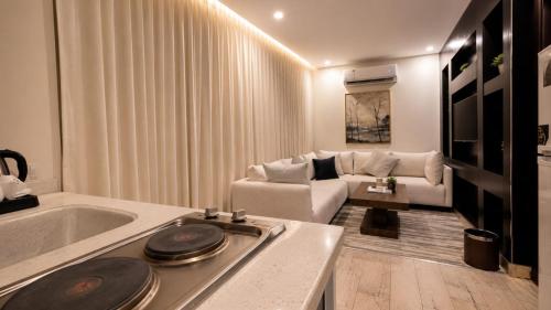 a living room with a bath tub and a couch at فندق حي الربوه Al Rabwah District Hotel in Tabuk