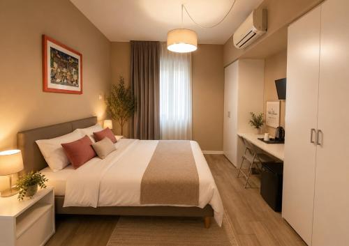 a hotel room with a bed and a desk at VILLA CHIARA Lago Maggiore in Gravellona Toce