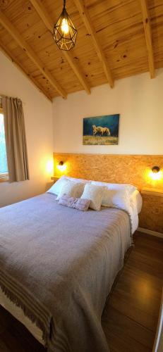 a bedroom with a large bed in a room at Cabaña Meely in El Calafate