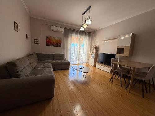 a living room with a couch and a table at Spiranca Cityview Residence in Tirana