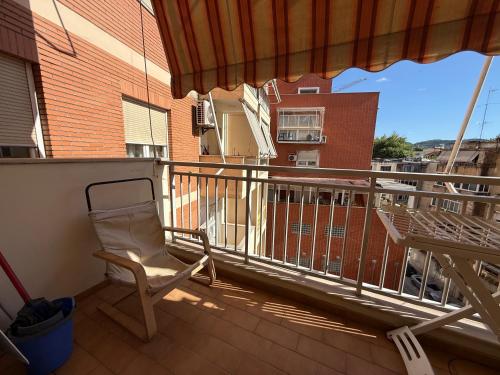 a chair sitting on the balcony of a building at Spiranca Cityview Residence in Tirana