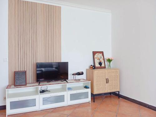 a white entertainment center with a television on top of it at Great for Families in Lourinhã-Double Rooms-Private Baths-Free Parking & Extra Bed in Lourinhã