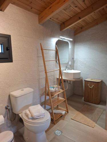 a bathroom with a toilet and a sink at Stones villa corfu in Varypatádes