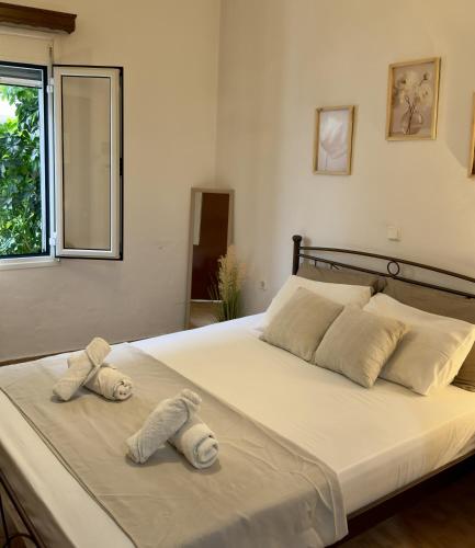 a bedroom with a large bed with towels on it at Chrysa's Studios in Loutra Edipsou
