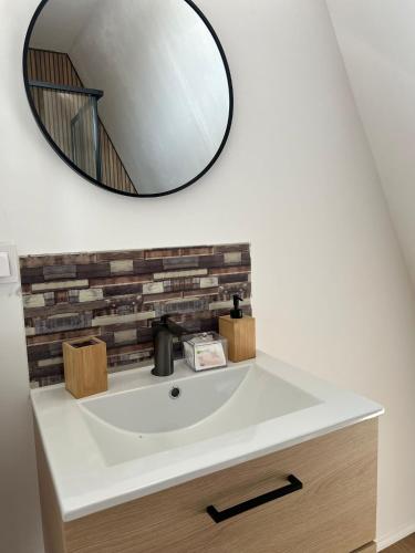 a bathroom sink with a mirror on the wall at Escape in Ghelar