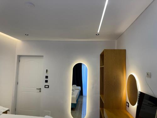 a white room with a bed and a door at Sorean HOTEL in Ksamil