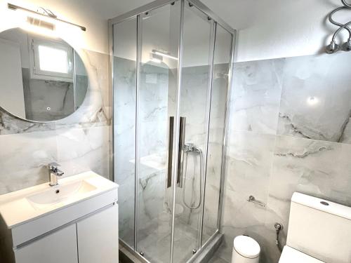 a bathroom with a shower and a sink at Κωνσταντίνος Έλενα Studios in Pefki