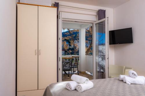 a bedroom with a bed with two towels at Apartments Gurman in Rab
