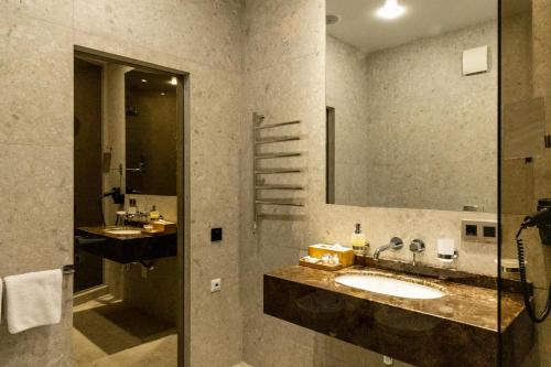 a bathroom with a sink and a mirror at Blu Mare Residense in Odesa
