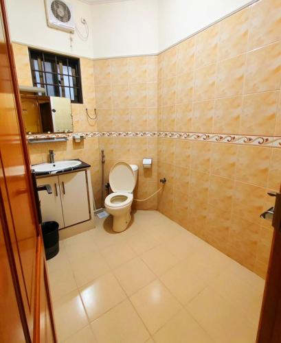 a bathroom with a toilet and a sink at Super Lodge by HFI in Islamabad