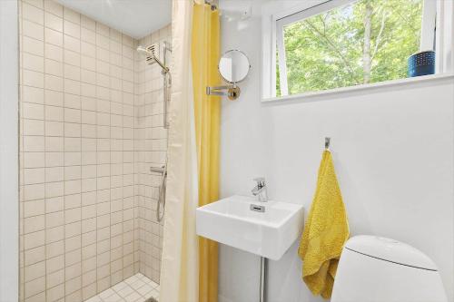 a bathroom with a sink and a toilet and a window at 1607-Vejby-Laerkebakken-8 in Vejby