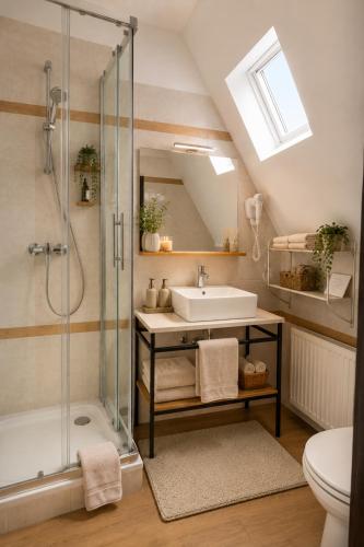 a bathroom with a sink and a shower at Drava Osijek in Osijek