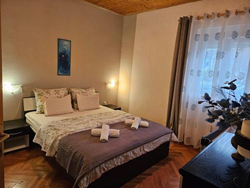 a bedroom with a bed with two towels on it at Apartment Tičić in Povljana
