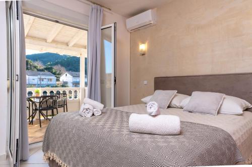 a bedroom with a large bed with towels on it at Apartments Gurman in Rab