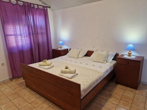 a bedroom with a large bed with two towels on it at Baka Jaka in Lumbarda