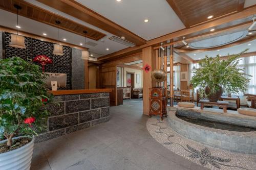a lobby with a fountain in the center of a building at Lijiang Cloud Return Huiyi · On the Water Side Panoramic Hidden Inn (South Gate Mufu Branch) in Lijiang