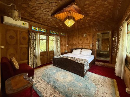 a bedroom with a bed and a chandelier at Lord Palace Houseboat in Srinagar