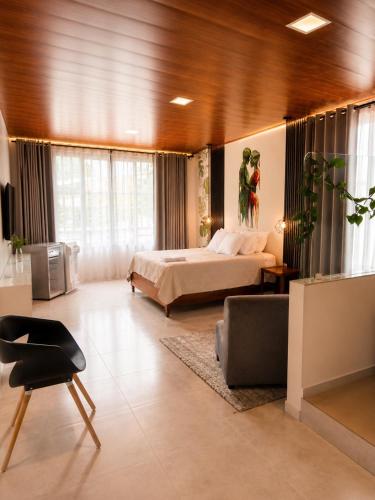a large bedroom with a bed and a chair at Wiky House Guaduas in Guaduas