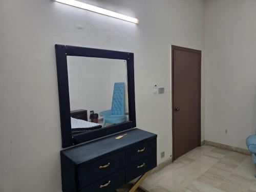 a mirror sitting on top of a dresser in a room at UrbanNOOK Basic in Rawalpindi