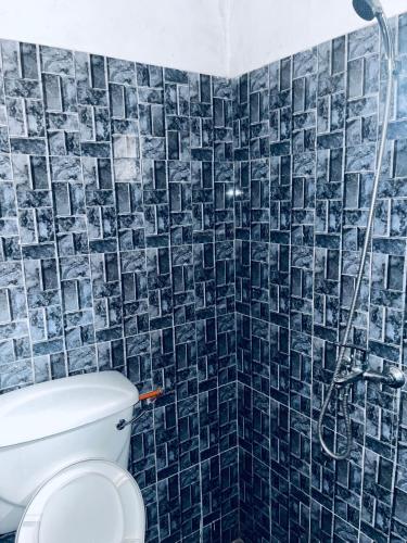 a bathroom with a toilet and a shower at Sumanya guest house 3 in Sukuta