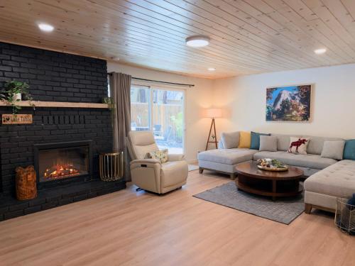 a living room with a couch and a fireplace at Pine Haven Tahoe-Cabin with Fire Pit, Grill & EV Charger in South Lake Tahoe