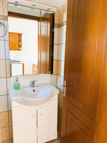 a bathroom with a sink and a mirror at Celestine Apartment, Arillas, Korfu in Arillas